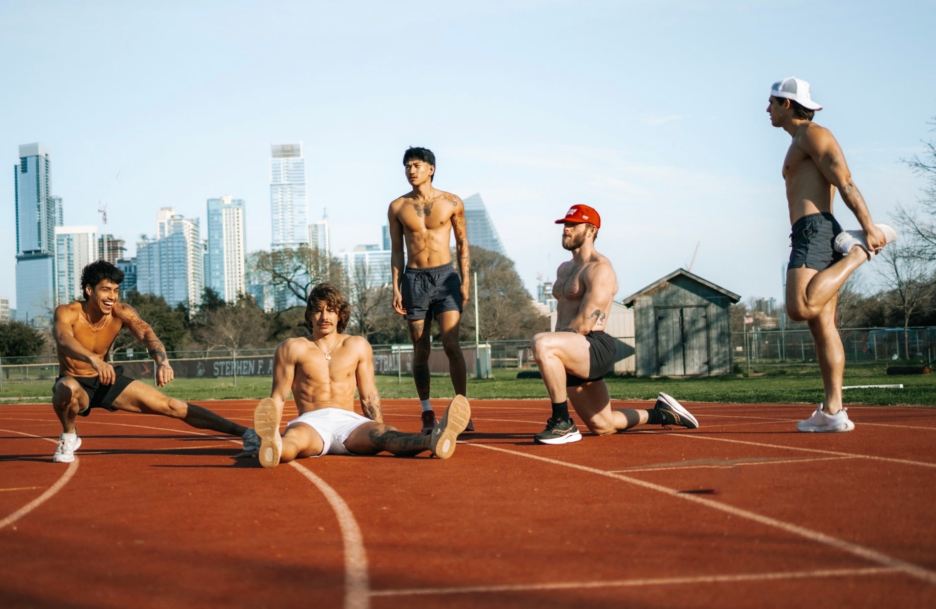 5 athletes stretching before a run together, all wearing men's mesh shorts with 4 inch inseams from SquidHaus