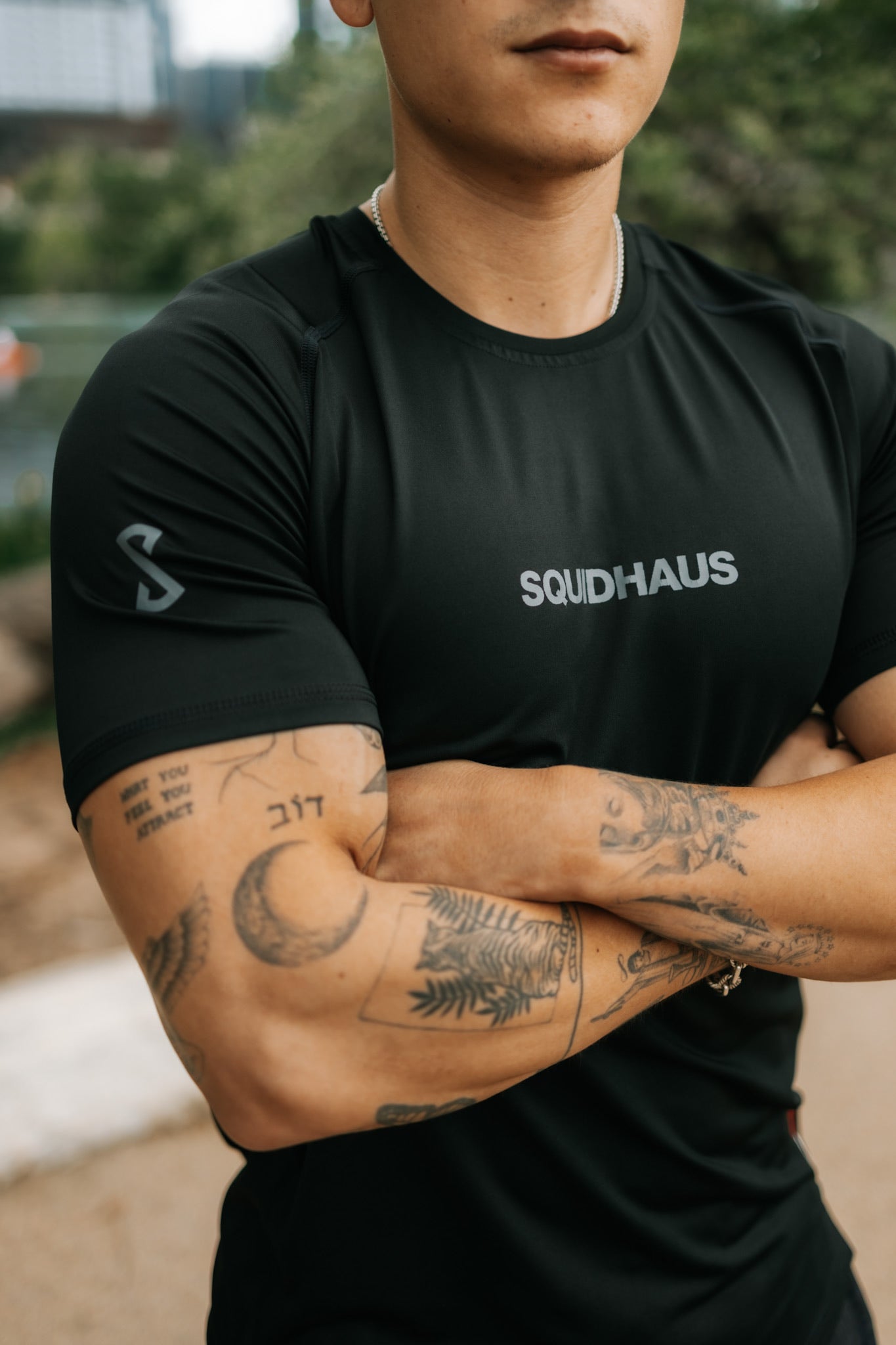 A model wearing the black Pro-tech V1 Athletic Fitted Short Sleeve T-Shirt by SquidHaus